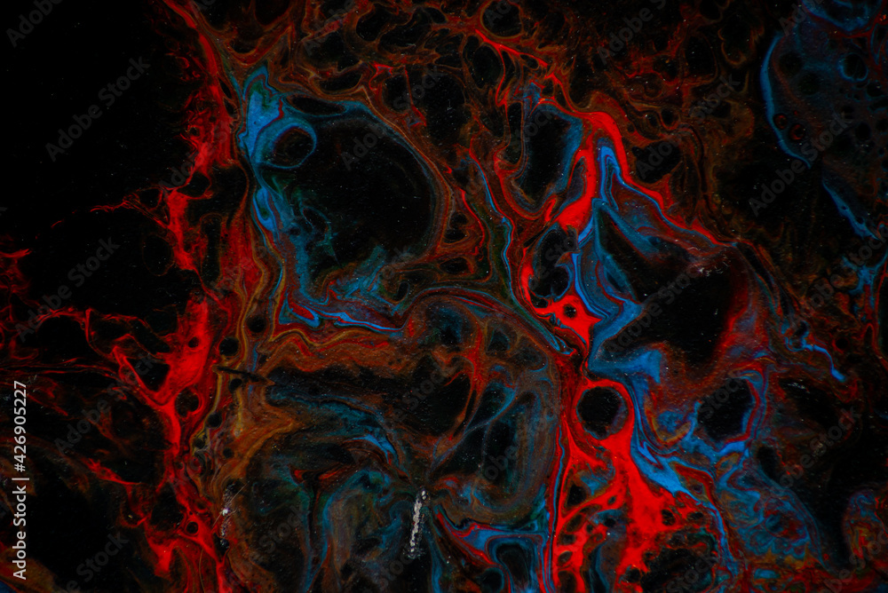 Fototapeta premium Texture in the style of fluid art. Abstract background with swirling paint effect. Liquid acrylic paint background. Black, blue and red colors.