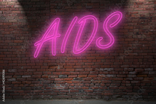 Neon AIDS (bondag, discipline, dominanc, submission) lettering on Brick Wall at night