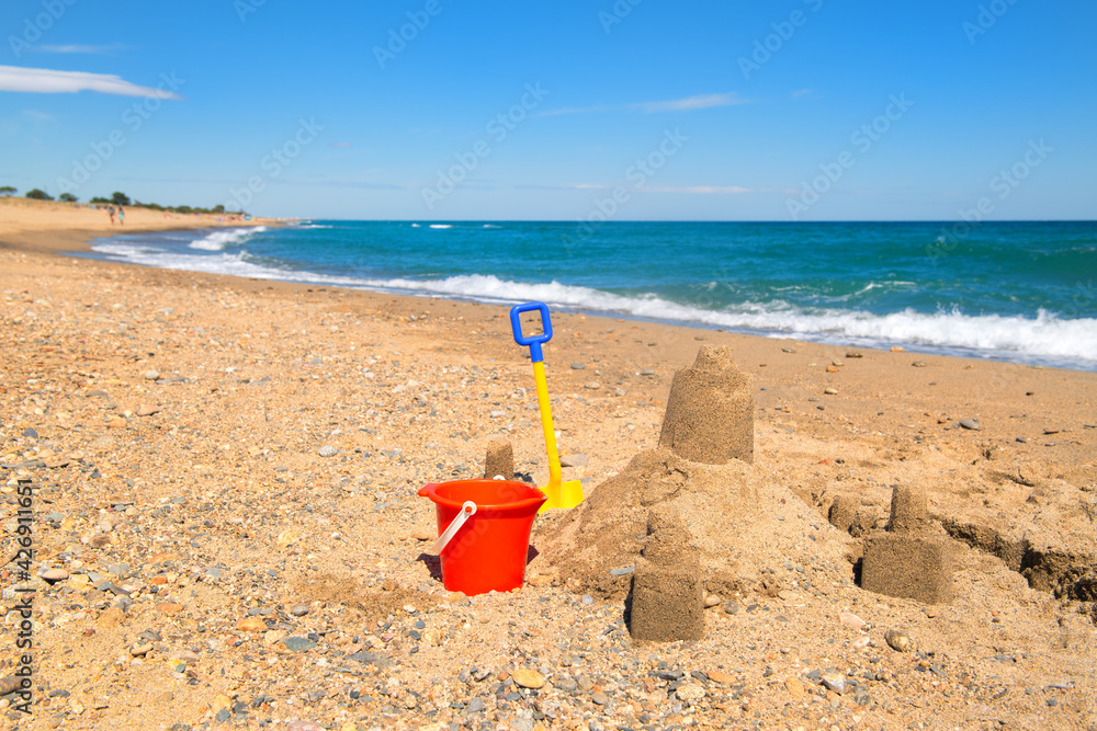 Toy buckets and sand castle at the beach Toy buckets and sand castle at the beach