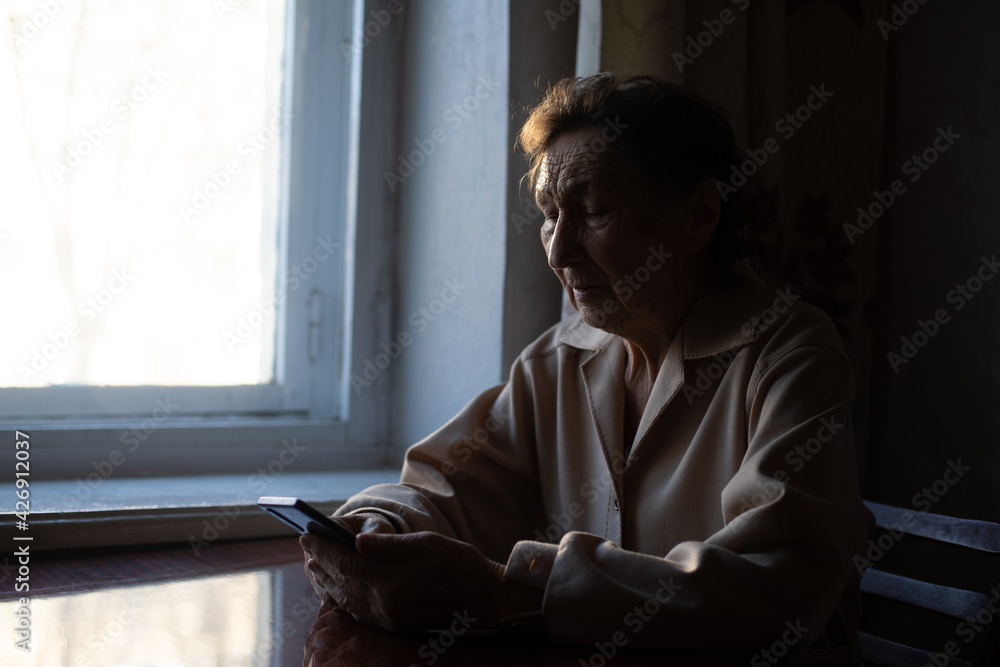 elderly lady with smartphone at home