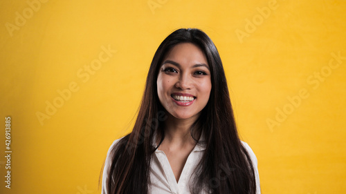 Young pretty woman laughs into the camera - studio photography © 4kclips