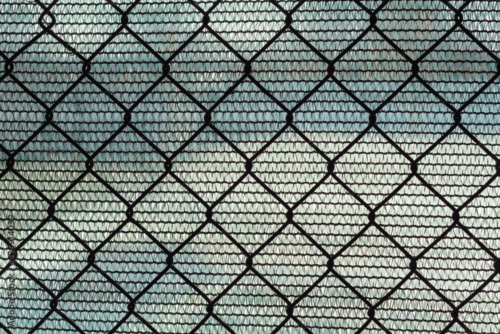 Fototapeta premium Fence made of metal mesh and plastic fabric.
