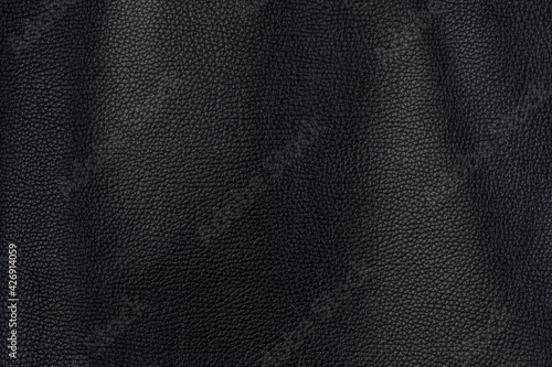 Black textured smooth leather surface background, medium grain © Dmitrii
