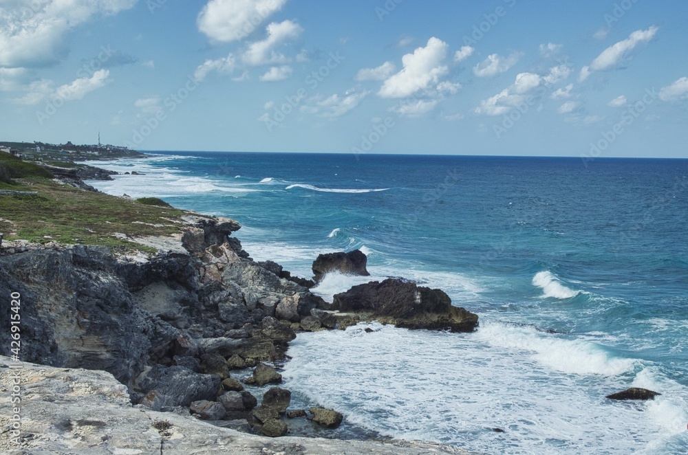 A view of rough sea water splashing against the rocks in Isla isla mujeres near Cancun, Mexico A view of rough sea water splashing against the rocks in Isla isla mujeres near Cancun, Mexico