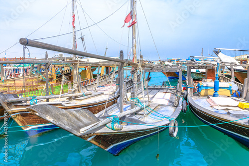 Al Khor, Qatar - February 23, 2019: fishing boats or traditional wooden dhows at harbor of Al Khor resort near Doha famous for its new Fish Market. Qatar, Middle East, Arabian Peninsula.