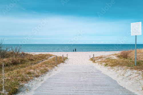 path leads to the blue water of the Baltic Sea and the sky is blue