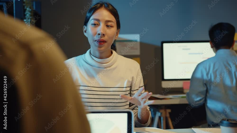 Asia businesspeople meeting plan analysis statistics brainstorm and header of team hold tablet point graph chart and employee take note in modern home office night. Finance strategy success concept.