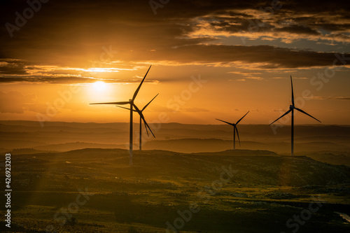 wind turbines at cloudy sunset