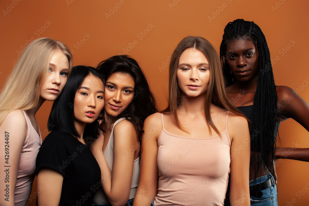 young pretty asian, caucasian, afro woman posing cheerful together on brown background, lifestyle diverse nationality people concept young pretty asian, caucasian, afro woman posing cheerful together on brown background, lifestyle diverse nationality people concept
