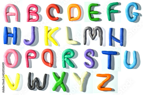 Colored English letters made of plasticine. Alphabet isolated on white background. Flat lay. copy the space.