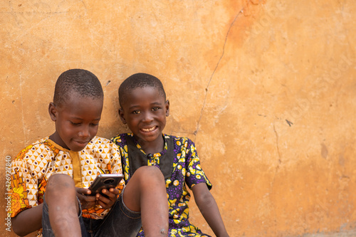 Photos african kids playing with a mobile phone