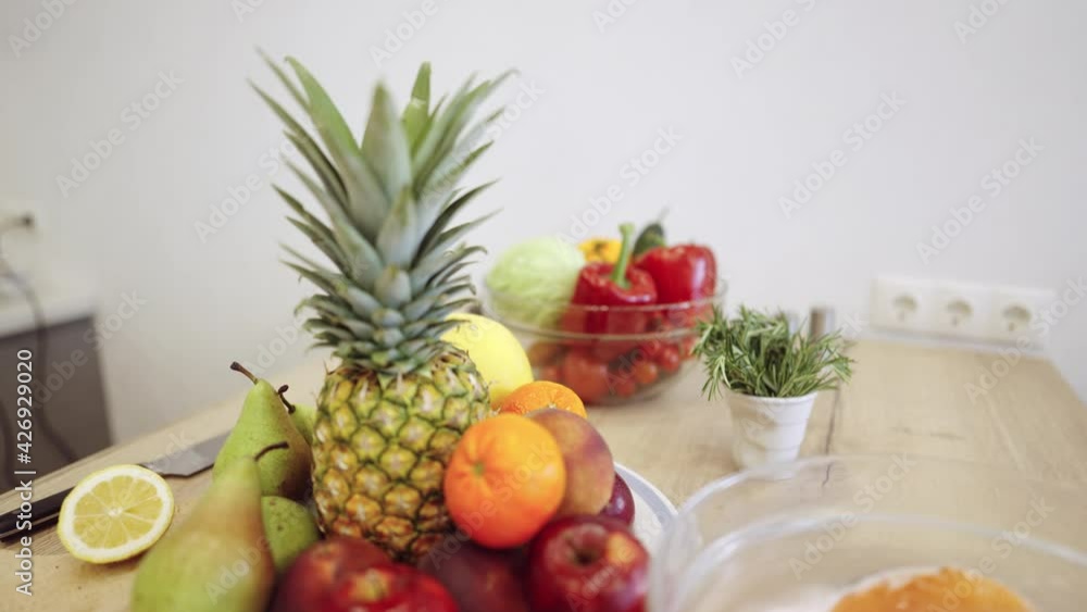 Bowl With Fruits And Vegetables On The Table Of Modern Kitchen Choice between fruits and vegetables on the table of modern kitchen. Vegan nutrition Bowl With Fruits And Vegetables On The Table Of Modern Kitchen Choice between fruits and vegetables on the table of modern kitchen. Vegan nutrition