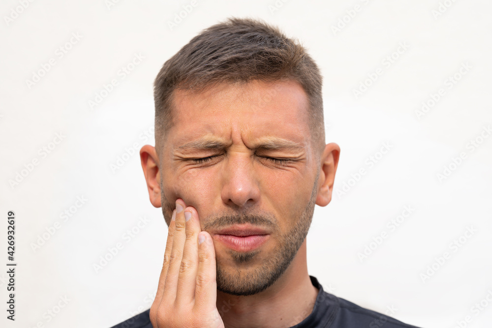 Man feeling strong tooth pain. Man suffering from toothache, dental illness or oral diseases. Teeth problem