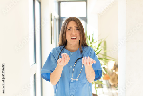 Obraz na plátně pretty nurse looking desperate and frustrated, stressed, unhappy and annoyed, sh