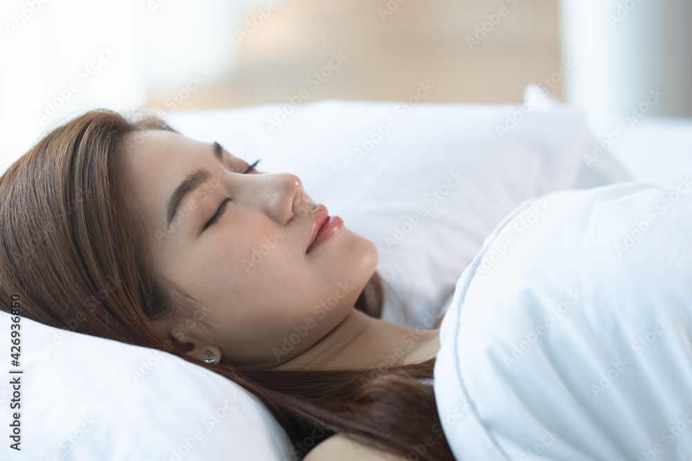 Asian women sleeping and sweet dream on white bed in bedroom Asian women sleeping and sweet dream on white bed in bedroom