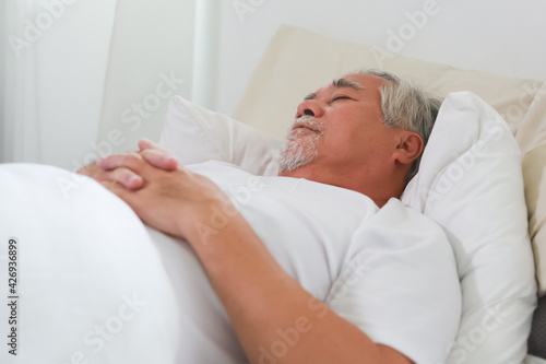 Asian Elderly man sleep and sweet dream on bed.
