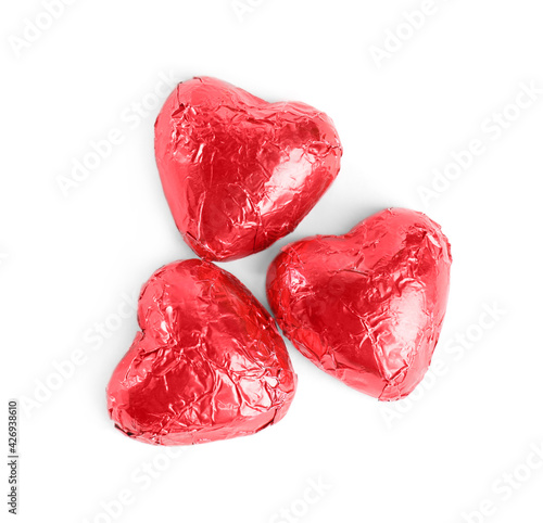 Heart shaped chocolate candies on white background, top view