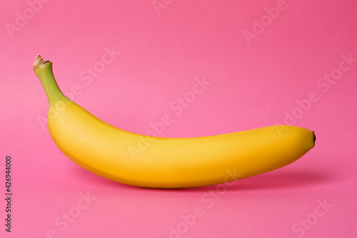 Ripe sweet yellow banana on pink background