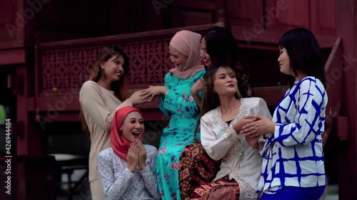 malay ethnic together in front traditional malay house greeting for eid celebration