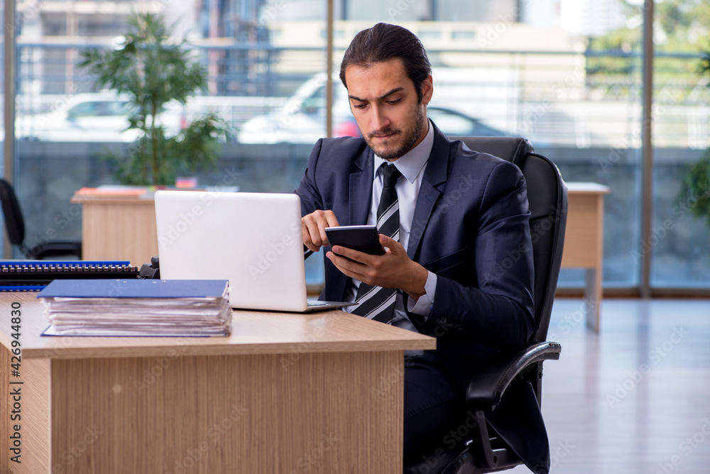 Fototapeta premium Young businessman employee working in the office