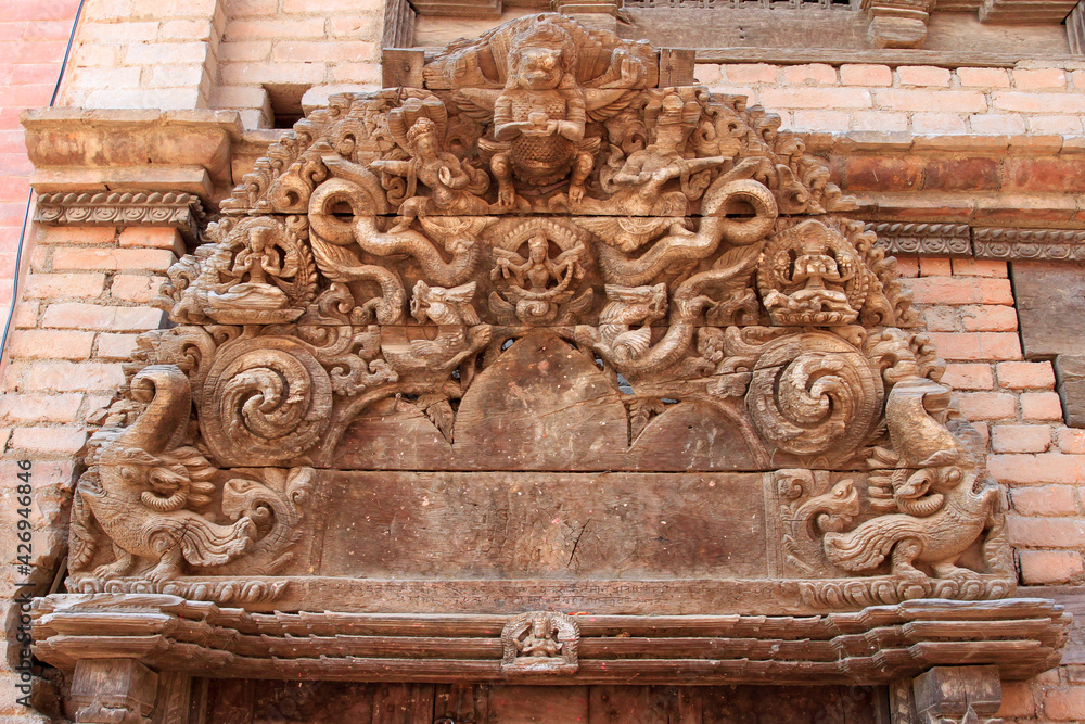 carved wood over doorway in Nepal