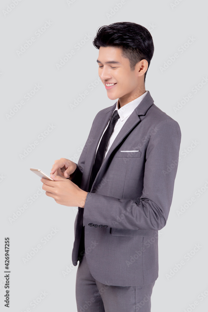 Portrait young asian business man in suit standing using smartphone to internet isolated on white background, businessman confident touch screen mobile phone with success, communication concept. Portrait young asian business man in suit standing using smartphone to internet isolated on white background, businessman confident touch screen mobile phone with success, communication concept.