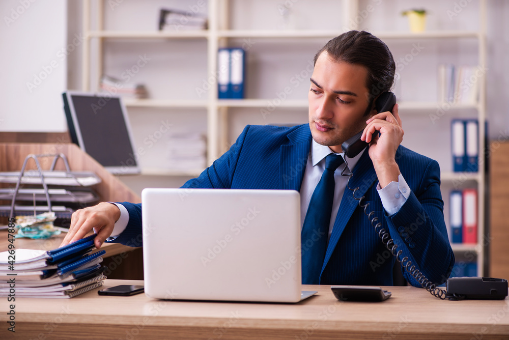 Young male employee working in the office Young male employee working in the office