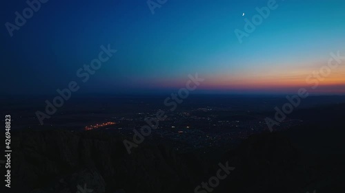 Skyline night view toward city lights from mountain hill, 4k video	