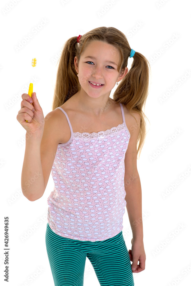 Smiling girl standing with toothbrush. Photo session in the studio Smiling girl standing with toothbrush. Photo session in the studio