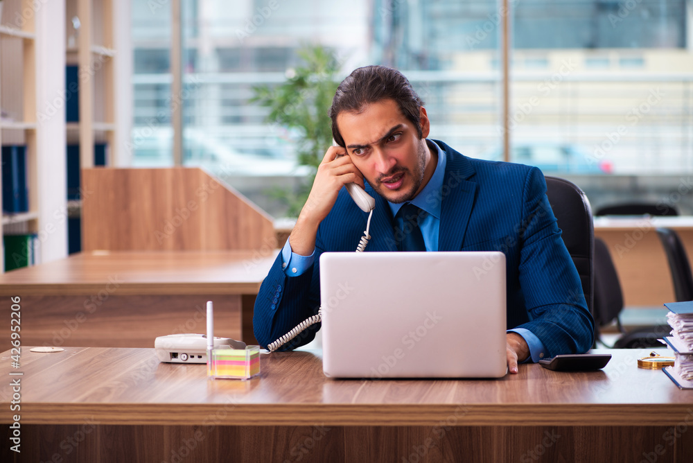 Young male employee working in the office Young male employee working in the office