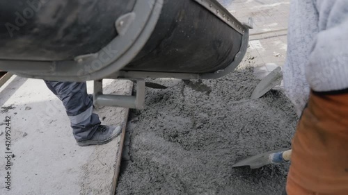 Truck mixer pouring concrete pipe cap. Concrete pouring during metal mold road surface.