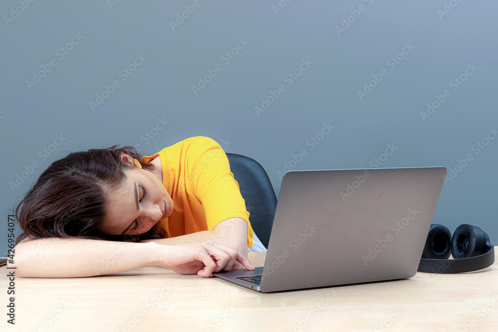 young female student sleeping near laptop during learning at home, distance online education young female student sleeping near laptop during learning at home, distance online education