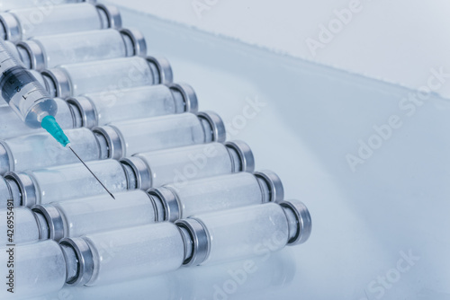 Medicine, Injection, vaccine and disposable syringe, drug concept. Sterile vial medical syringe needle. Glass medical ampoule vial for injection.