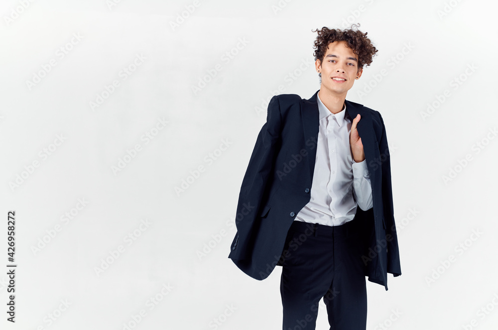 teenager in classic suit with jacket in hand and light background cropped view of pants teenager in classic suit with jacket in hand and light background cropped view of pants