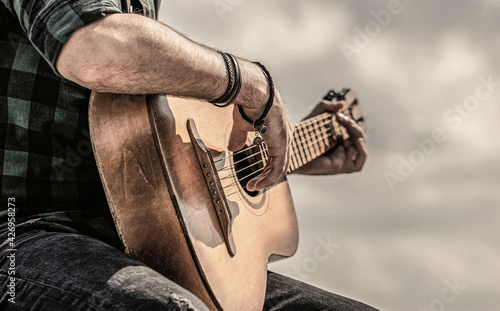 Man hands playing acoustic guitar, close up. Acoustic guitars playing. Music concept. Guitars acoustic. Male musician playing guitar, music instrument