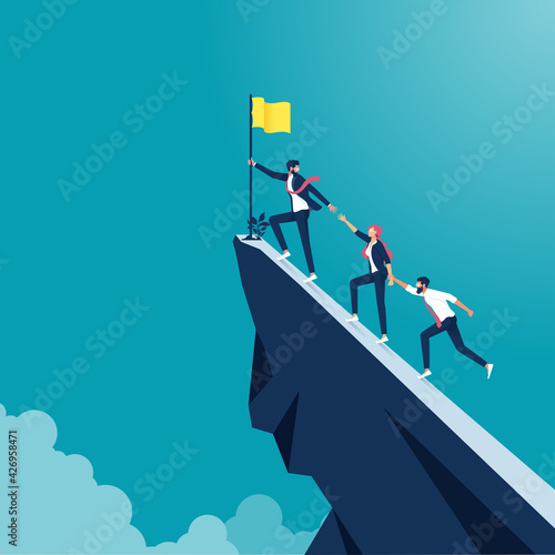 Business concept of teamwork and leadership, Business people climb to the top of the mountain, leader helps the team to climb the cliff 