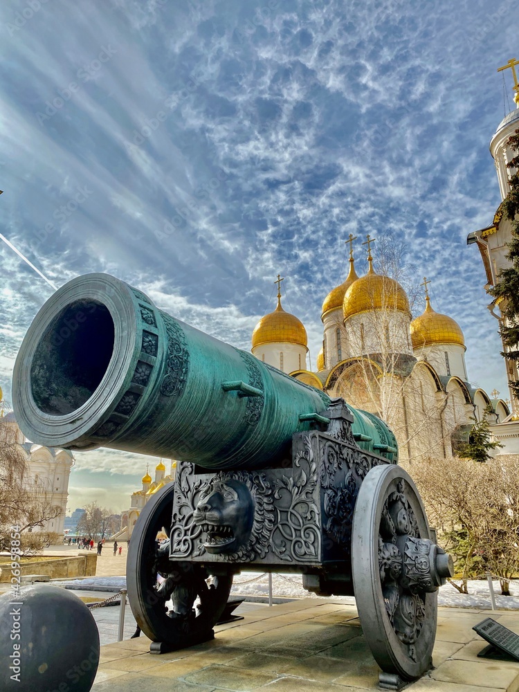 Tsar Cannon in front of the Dormition Cathedral (Uspensky Sobor) of the Moscow Kremlin on a bright sunny day. Moscow, Russia. Tsar Cannon in front of the Dormition Cathedral (Uspensky Sobor) of the Moscow Kremlin on a bright sunny day. Moscow, Russia.