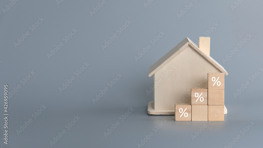 Wooden house with a stairs of wooden block written with percentage on gray background with copy space. - obrazy, fototapety, plakaty 