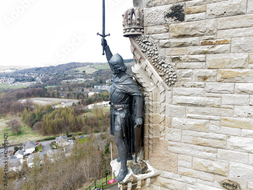 William Wallace statue stands proudly.The National Wallace Monument is a tower standing on a hilltop in Stirling in Scotland.It commemorates Sir William Wallace, a 13th and 14th-century Scottish hero. photo