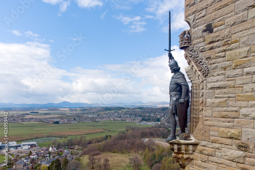 William Wallace statue stands proudly.The National Wallace Monument is a tower standing on a hilltop in Stirling in Scotland.It commemorates Sir William Wallace, a 13th and 14th-century Scottish hero. photo