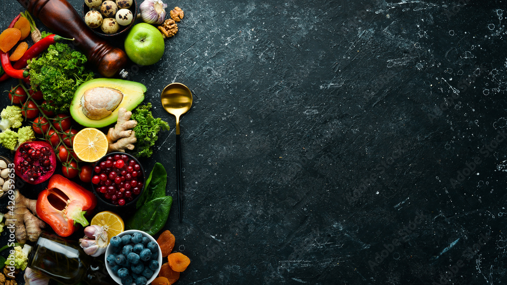 Healthy food background. Concept of Healthy Food, Fresh Vegetables, Nuts and Fruits. On a stone background. Top view. Copy space