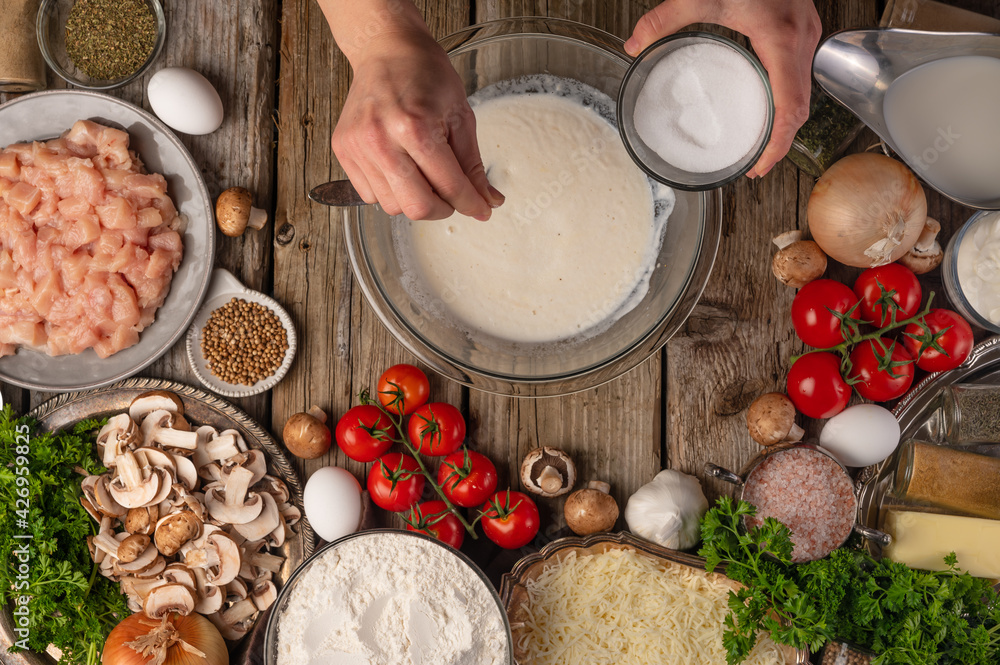 Fototapeta premium chef prepares kneading dough, ingredients background.On old wooden table, cooking pizza or pie, top view flat lay