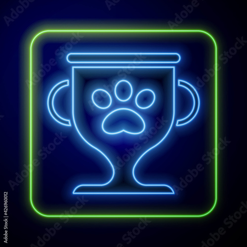 Glowing neon Pet award symbol icon isolated on blue background. Medal with dog footprint as pets exhibition winner concept. Vector