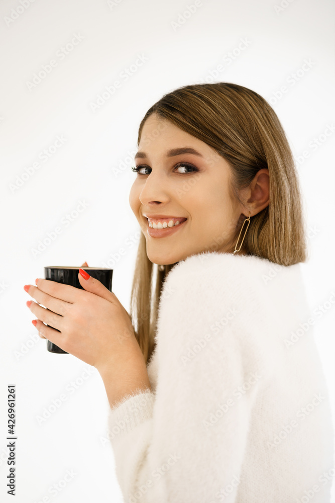 Young smiling beautiful happy woman with long hair enjoying cappuccino on white background. Beauty Woman enjoying Coffee. Cup of Hot Beverage. Young smiling beautiful happy woman with long hair enjoying cappuccino on white background. Beauty Woman enjoying Coffee. Cup of Hot Beverage.