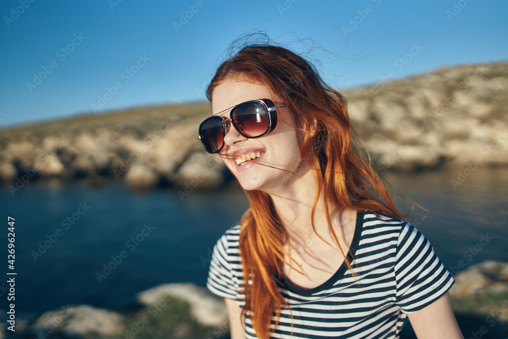 portrait of a woman wearing glasses outdoors in the mountains tourism travel clear water lake river