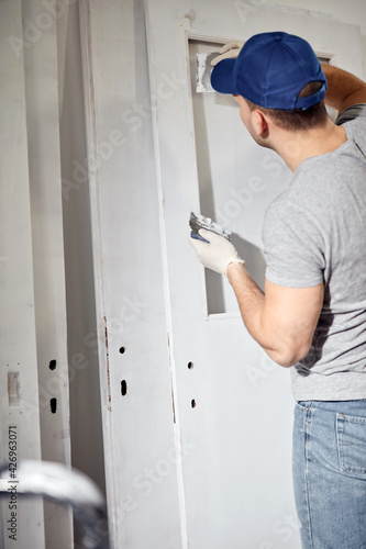 Wallpaper Mural Young adult man working on a DIY budget renovation of his new home apartment. Torontodigital.ca