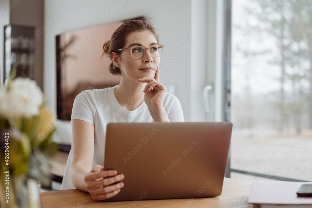 Pensive young businesswoman staring aside into the air Pensive young businesswoman staring aside into the air