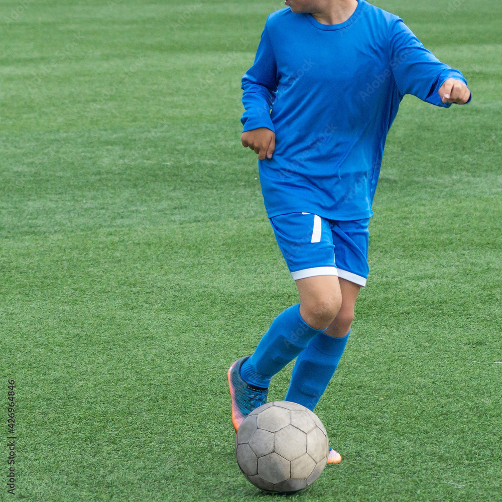 Children's football. Children are playing football. The active struggle and dynamics of the boys' soccer match. The boys are recklessly fighting for the ball Children's football. Children are playing football. The active struggle and dynamics of the boys' soccer match. The boys are recklessly fighting for the ball