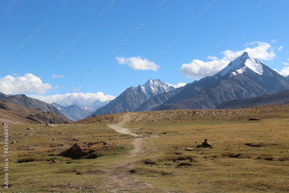 Landscape of the Himalayan peaks with a trail leading towards the mountains