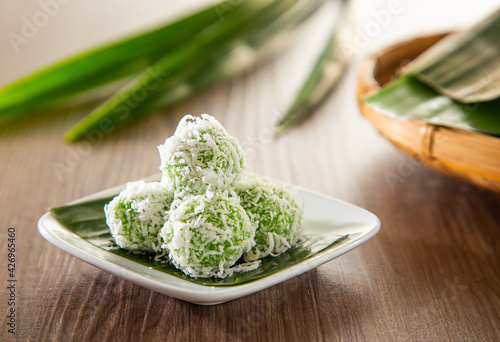 Onde onde is a traditional Malay snack made of rice ball filled with brown sugar, coated in grated coconut. photo
